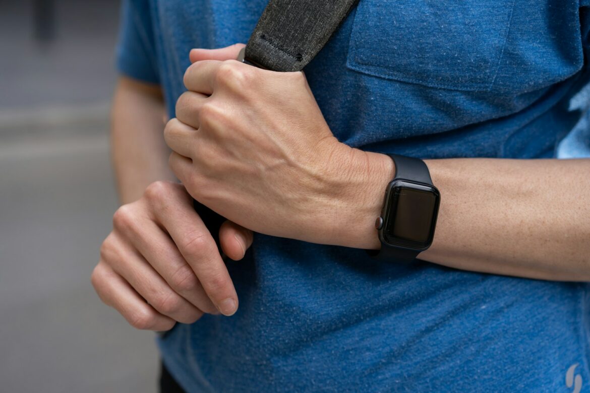 Looking down at woman's hand wrist wearing black apple watch a health fitness