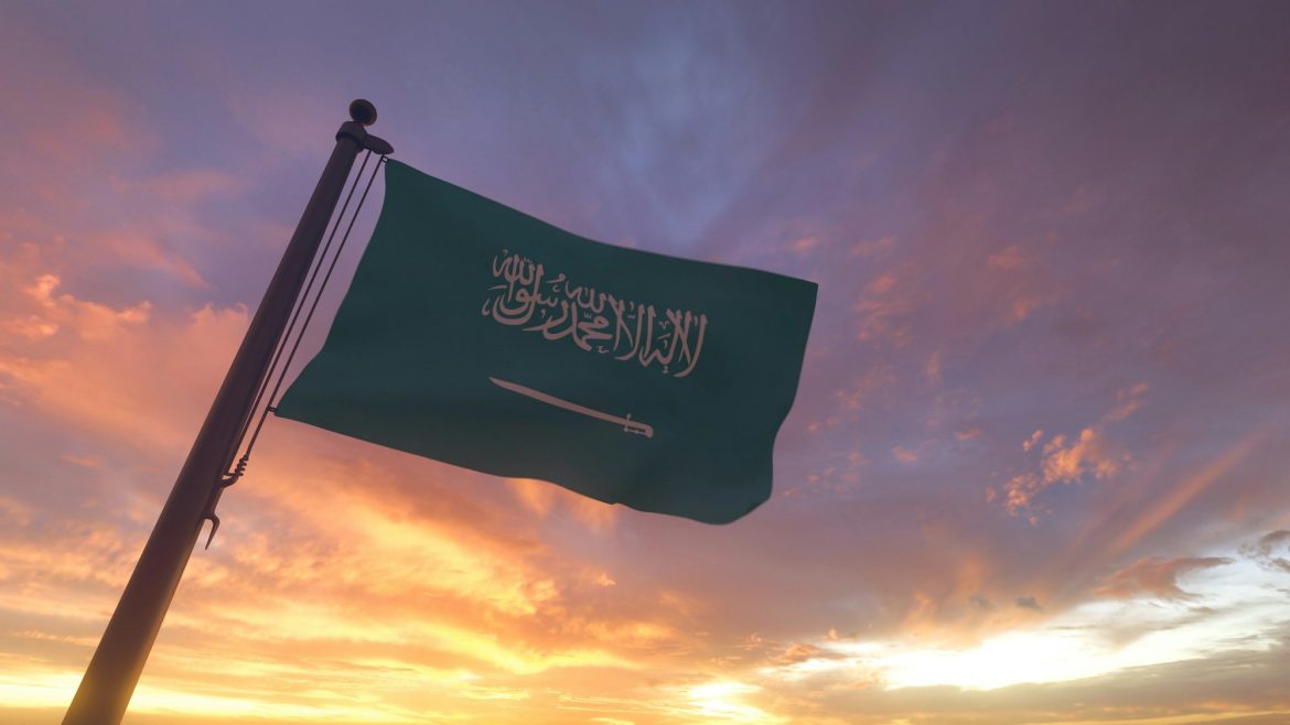 Saudi Arabia Flag on Flagpole by Evening Sunset Sky