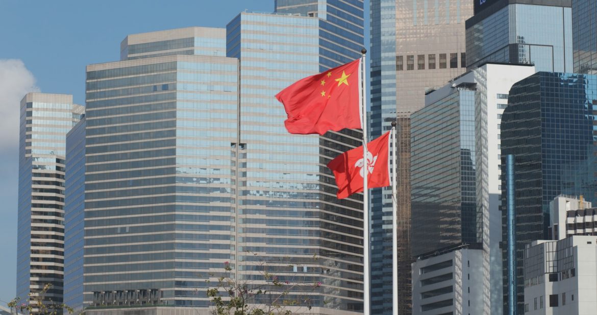 Central, Hong Kong, 10 April 2018:- Hong Kong and China flag with business office tower