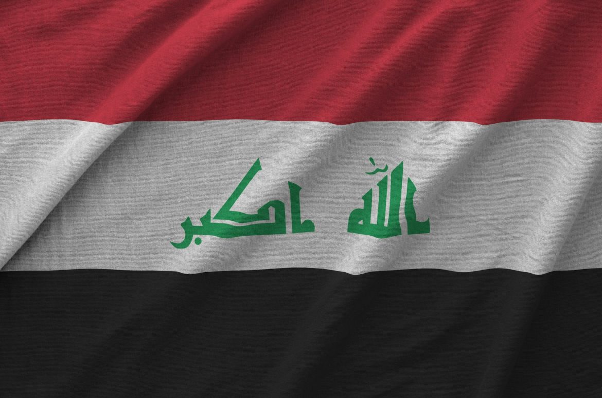 Iraq flag depicted on folded wavy fabric of old cloth