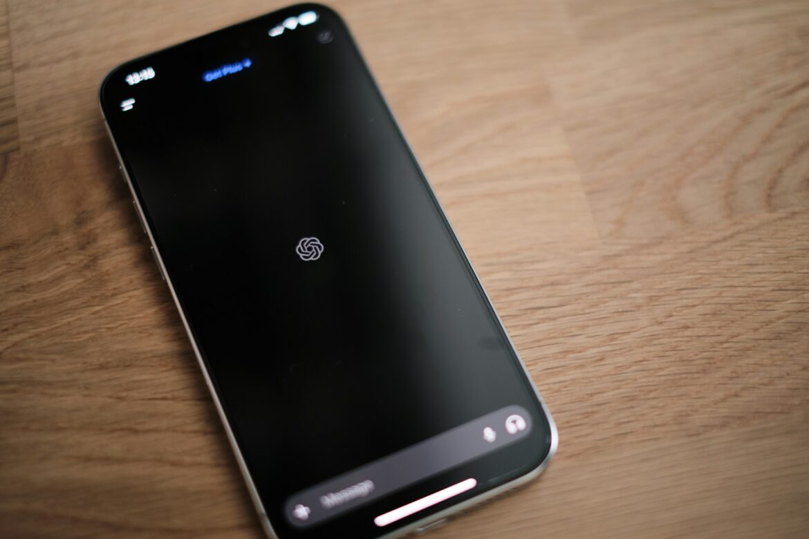 Photo by appshunter.io A cell phone sitting on top of a wooden table