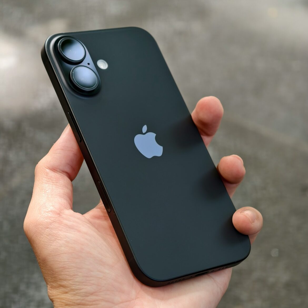 Photo by Thai Nguyen A person holding an iPhone in their hand