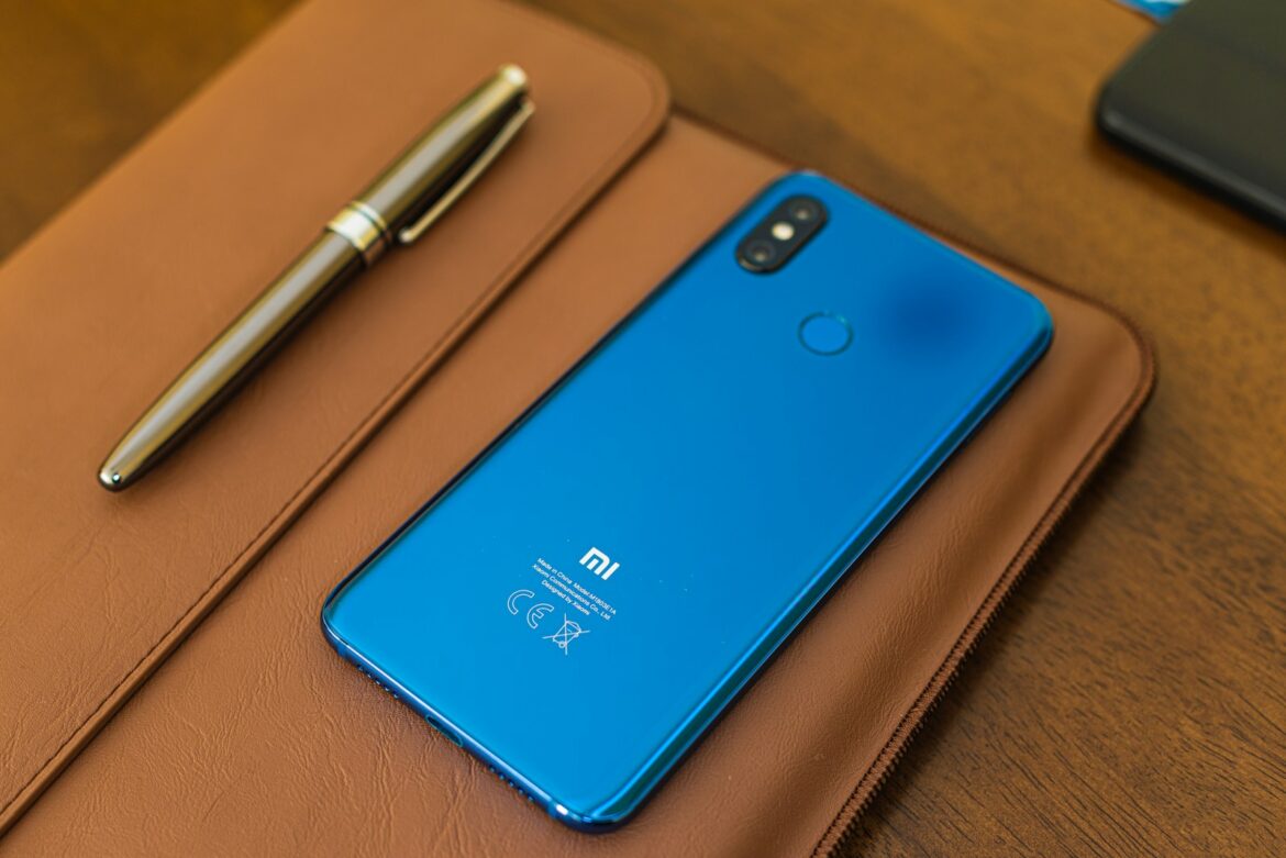 shallow focus photo of blue Xiaomi smartphone