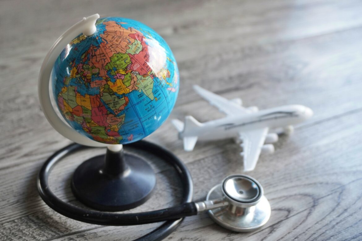 Selective focus image of globe, toy plane and stethoscope. السياحة العلاجية