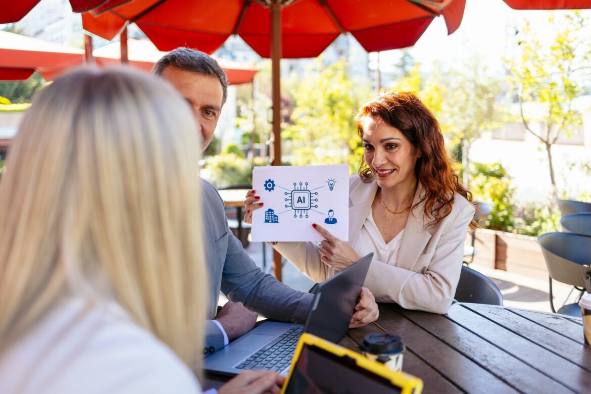 Business team analyzing artificial intelligence solutions during a meeting at an outdoor cafe
