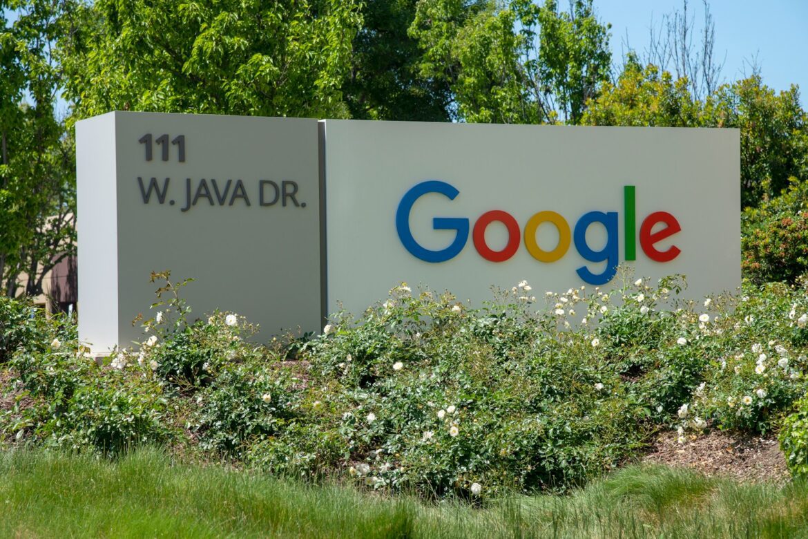 Photo by Greg Bulla a google sign in front of some bushes and trees