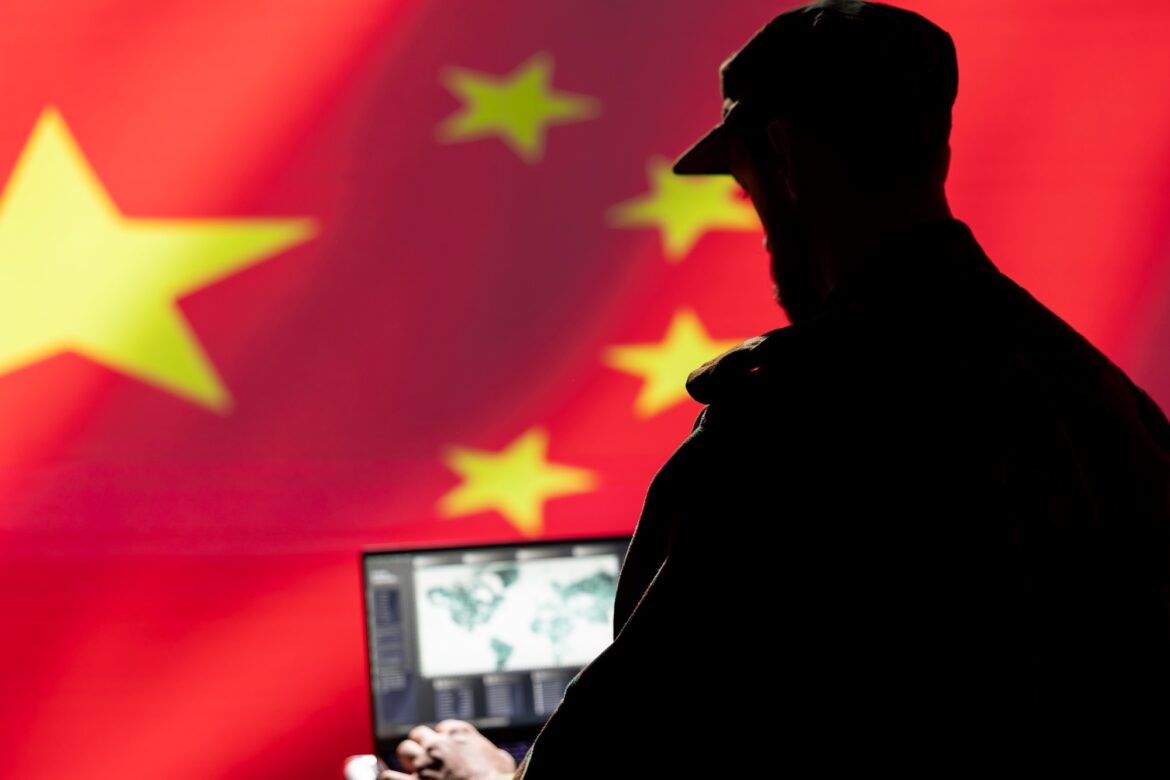 Military officer isolated over China flag using satellite technology gear