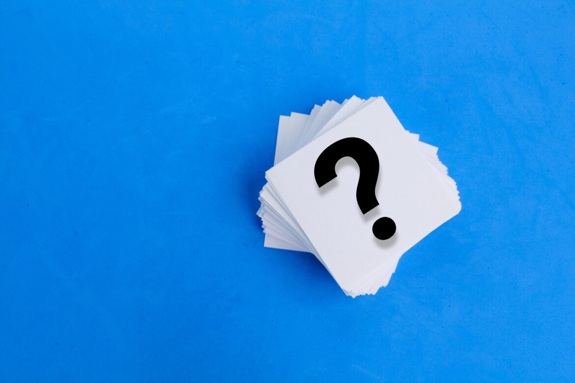 white paper with a question mark or question mark. white paper with a question mark or question mark.
