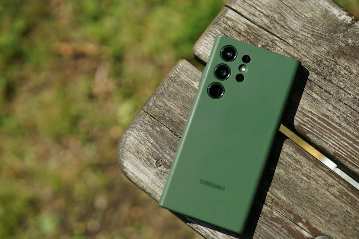 Photo by Ian Edokov a green cell phone sitting on top of a wooden bench