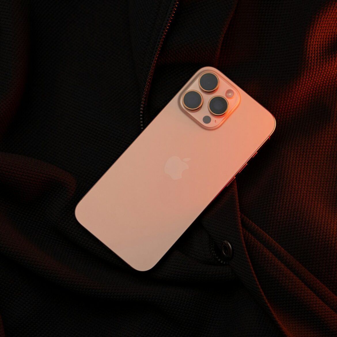 Photo by Sayan Majhi A white iPhone case sitting on top of a black jacket