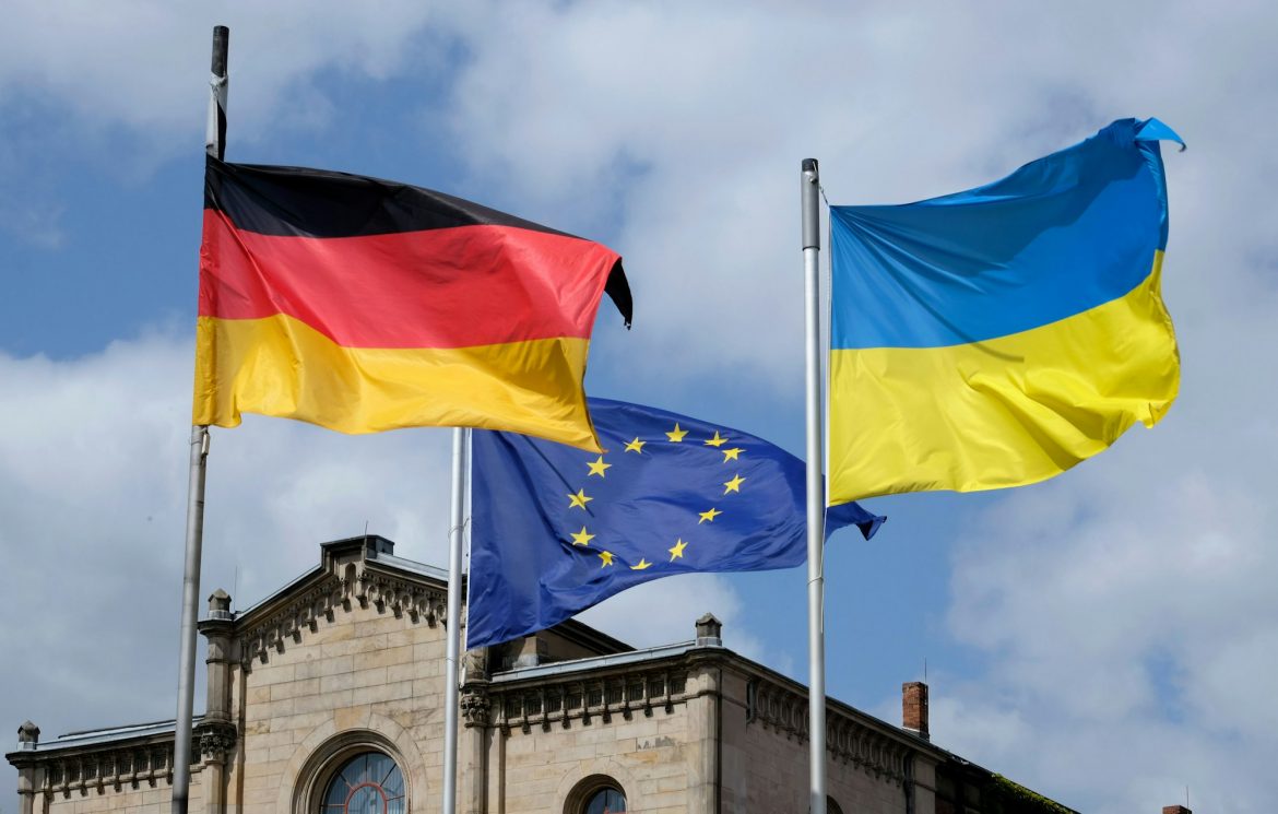 Flags of Ukraine, Germany, and the EU waving in the wind