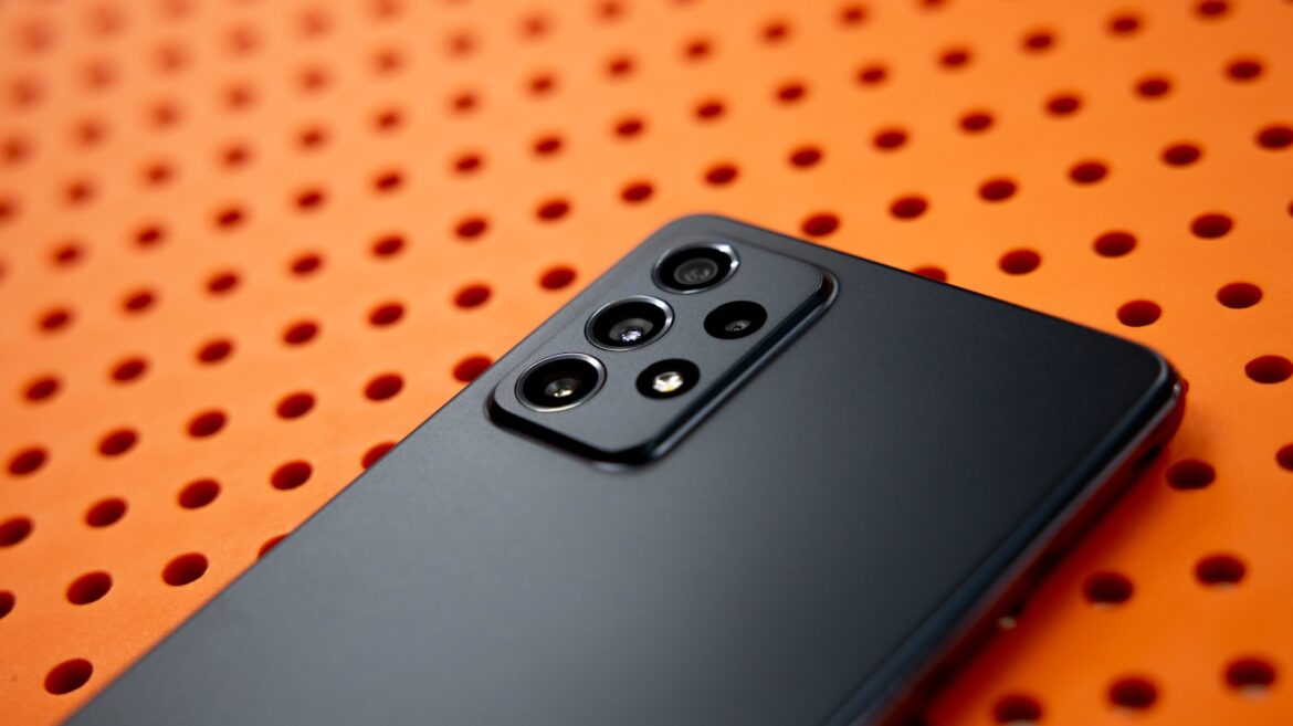 black remote control on orange and white polka dot textile