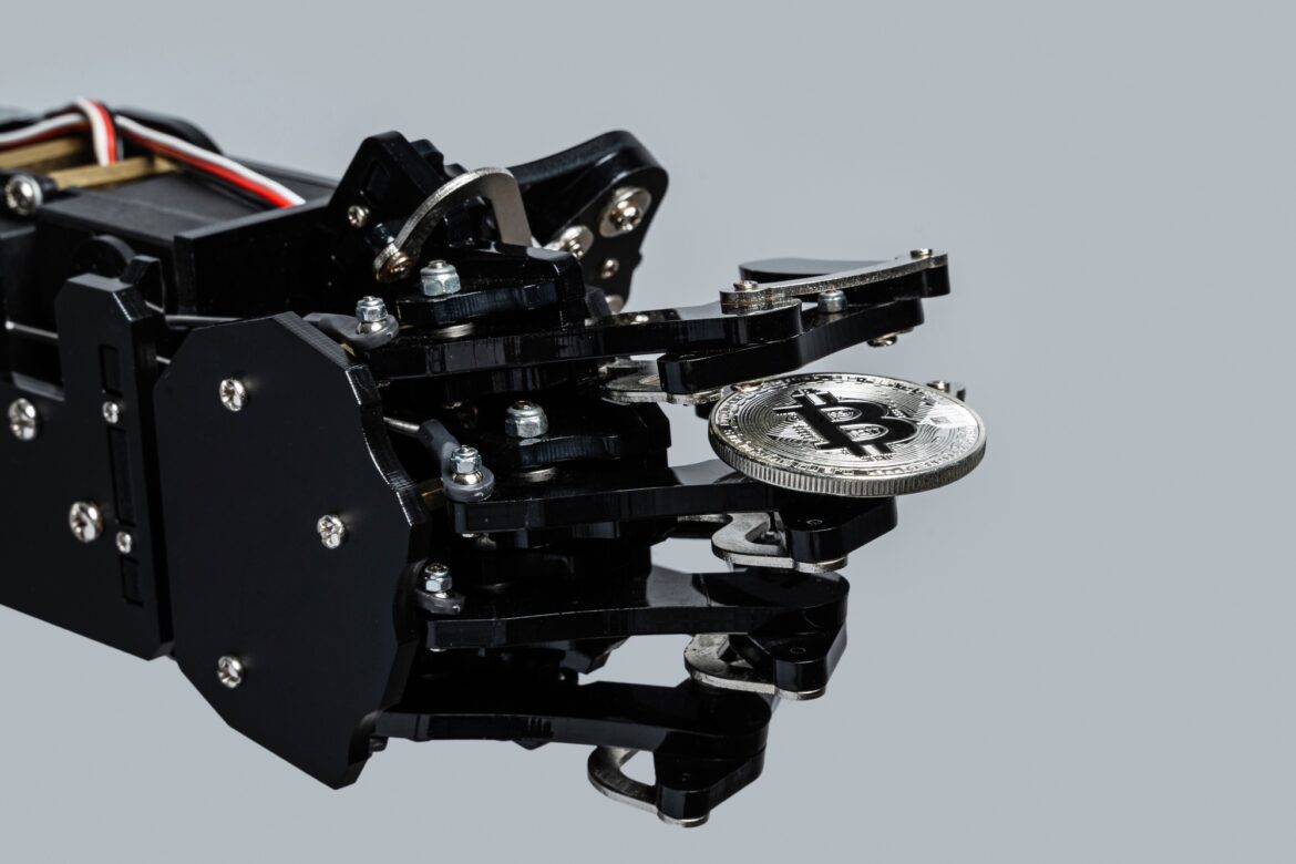 Real robotic hand with bitcoin.