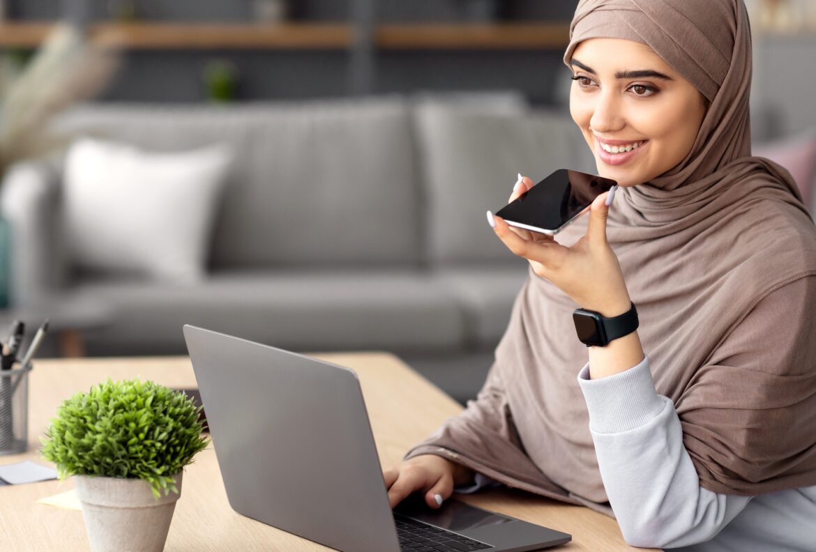 Muslim woman using voice search assistant on smart phone