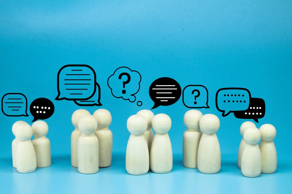 peg doll with message notification icon, chat social media interaction.