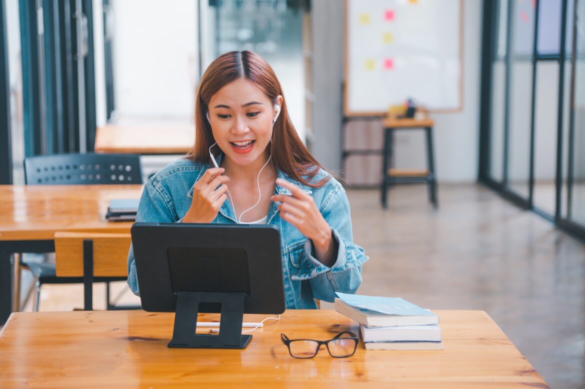 young student wearing small talk studies online, distance learning