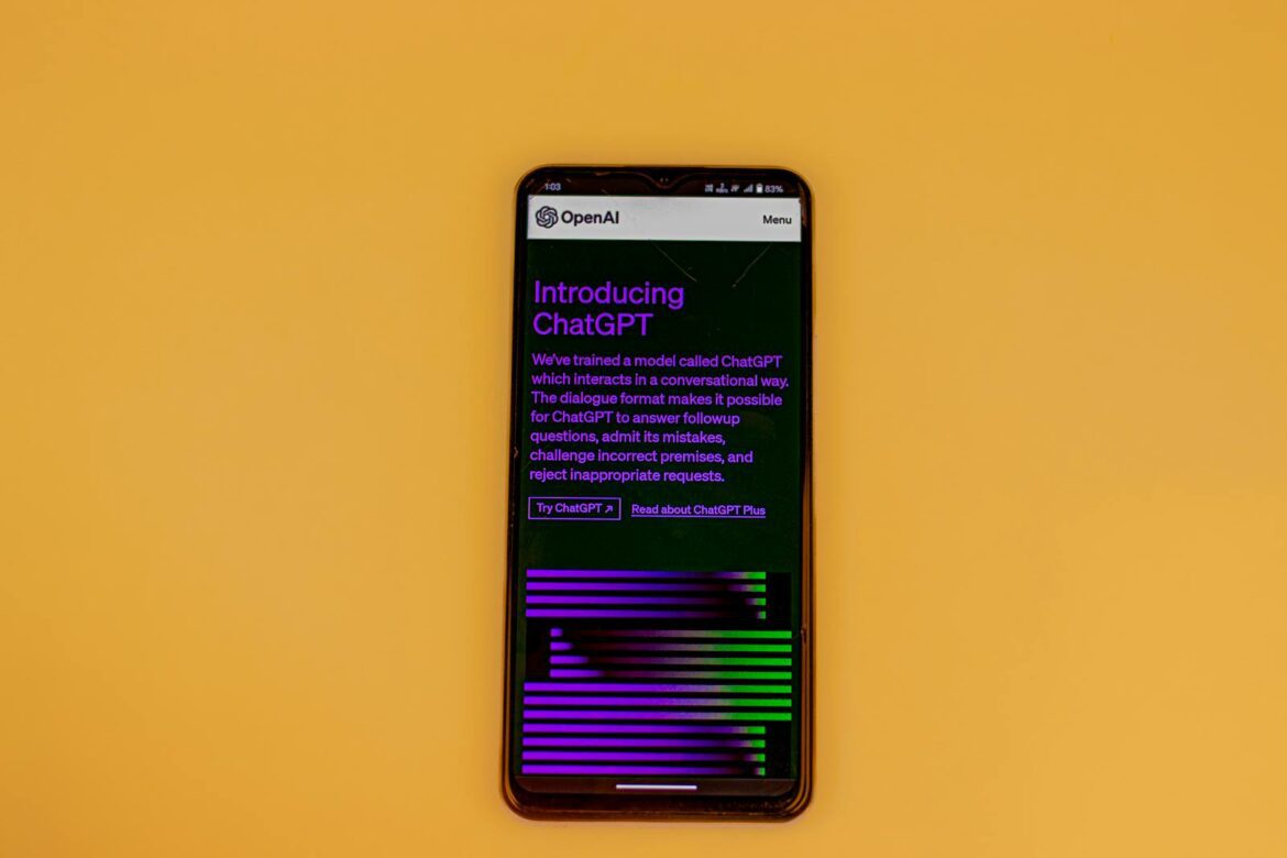 Smartphone displaying ChatGPT interface on a vibrant background, showcasing AI technology.